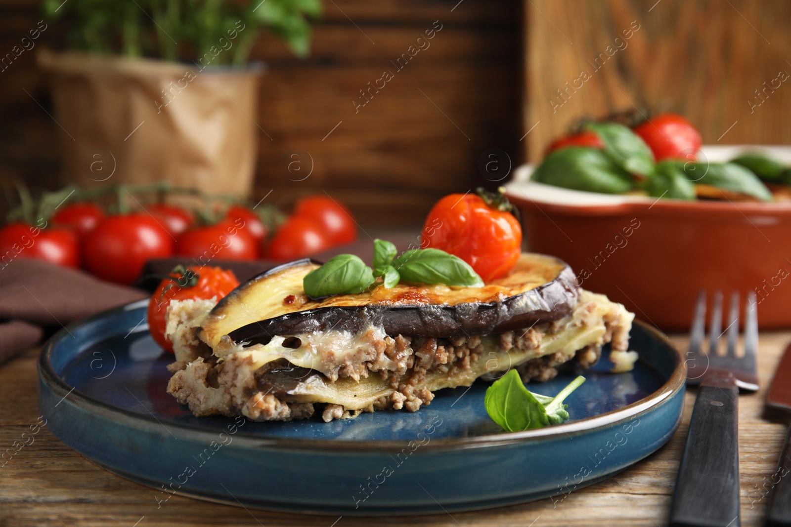 Photo of Delicious eggplant lasagna served on wooden table, closeup