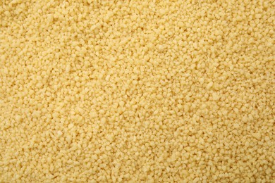 Photo of Uncooked organic couscous as background, top view