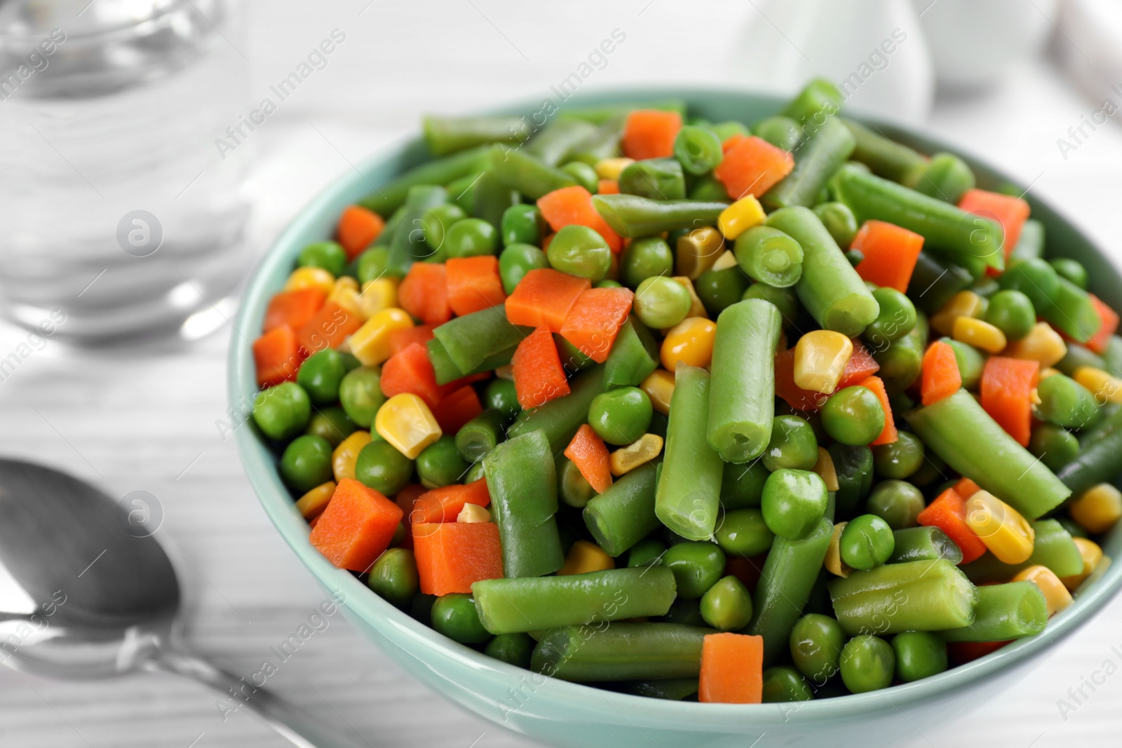 Photo of Mix of fresh vegetables served on white wooden table, closeup