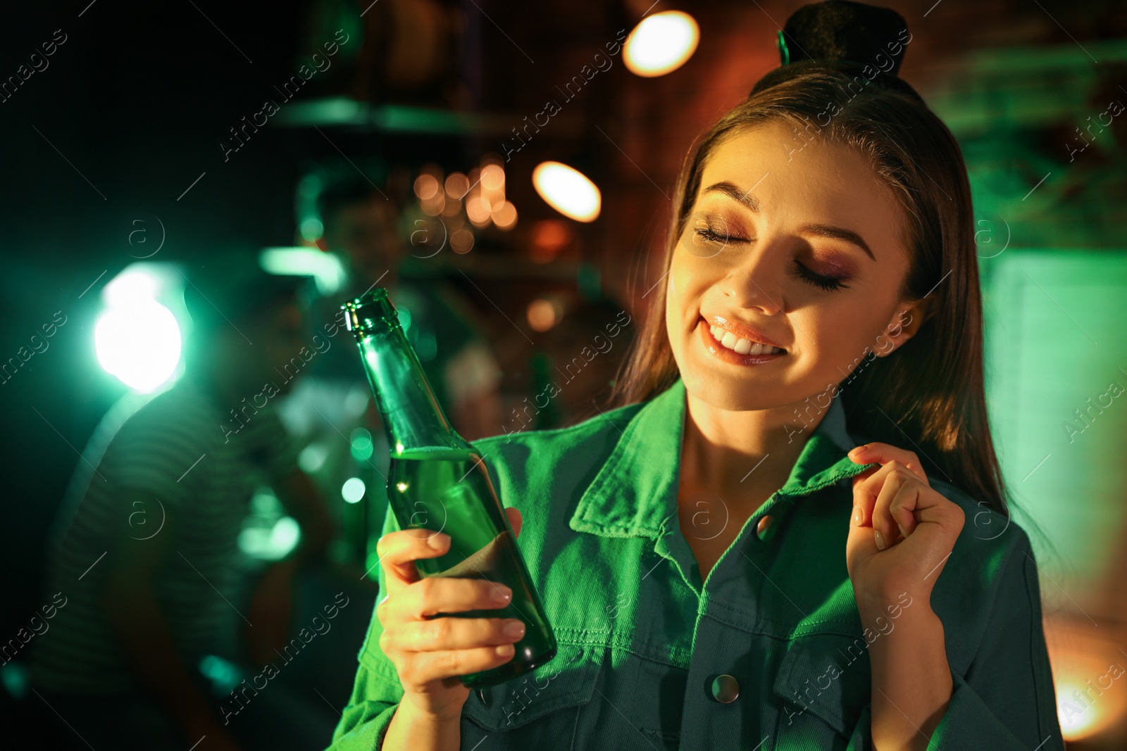 Photo of Woman with beer celebrating St Patrick's day in pub