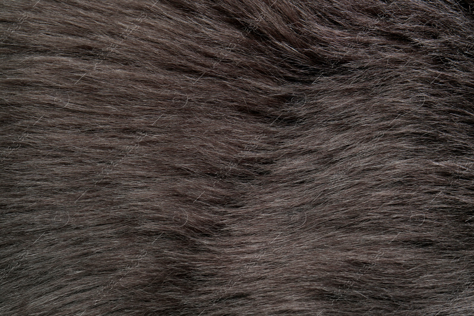 Photo of Beautiful dark faux fur as background, top view