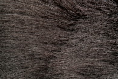 Photo of Beautiful dark faux fur as background, top view