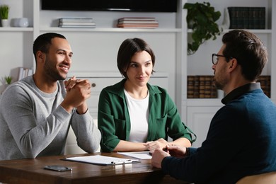 Professional notary working with couple in office