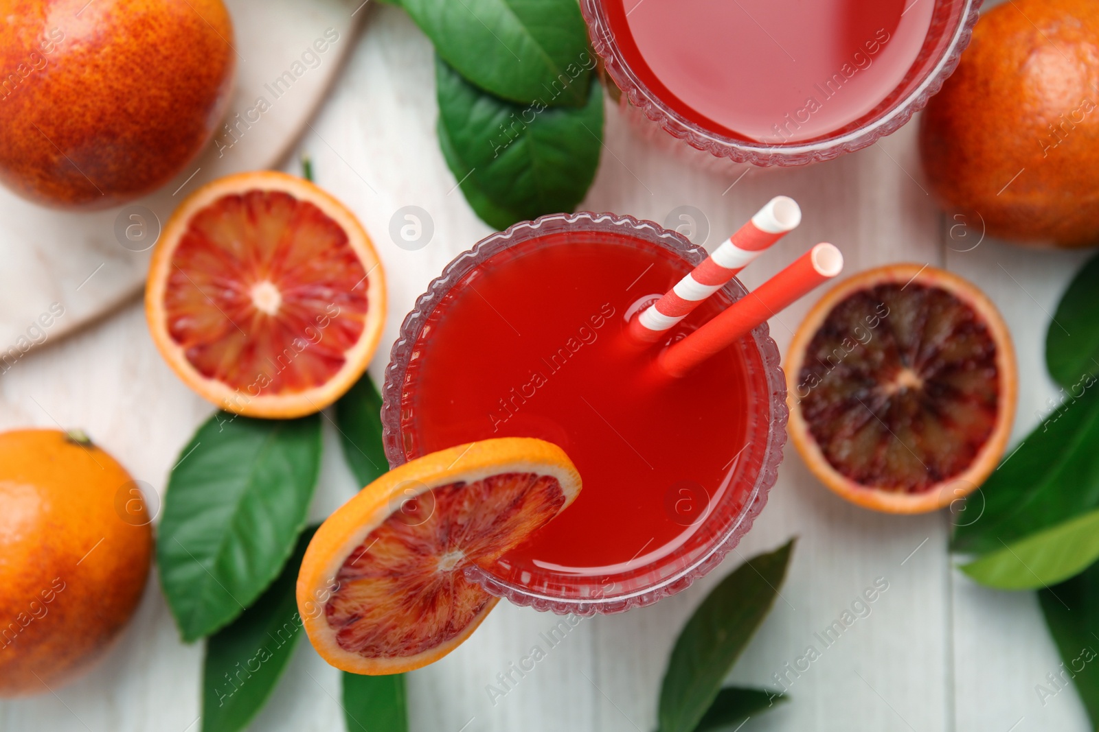 Photo of Tasty sicilian orange juice and fruits on white wooden table, flat lay