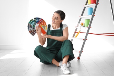 Photo of Female decorator with color palette indoors