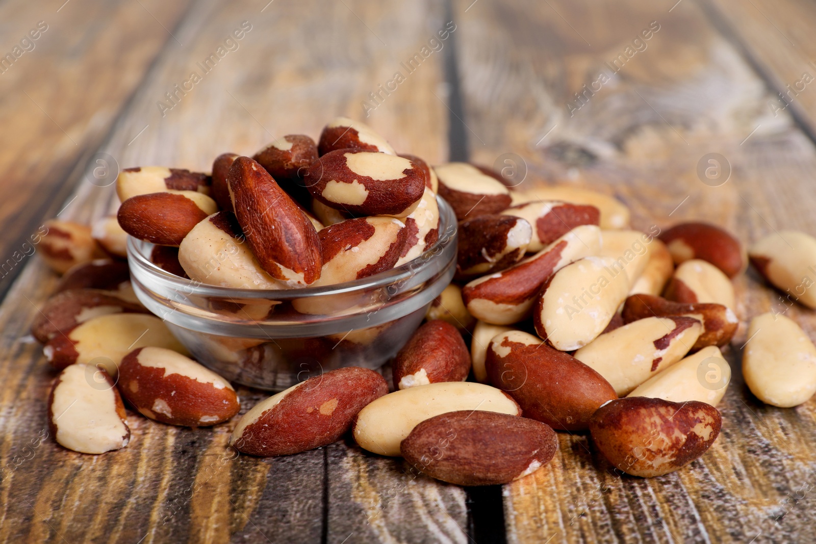 Photo of Many delicious Brazil nuts on wooden table