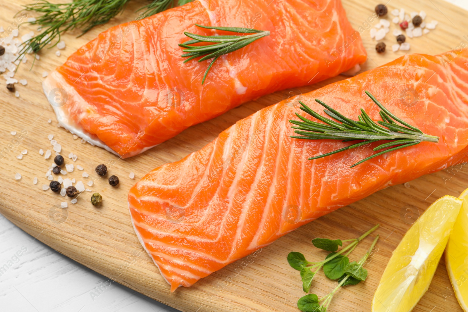 Photo of Fresh salmon and ingredients for marinade on wooden board, closeup