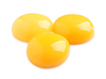 Photo of Raw chicken egg yolks on white background