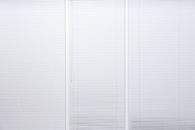 Photo of Window with closed white horizontal blinds as background