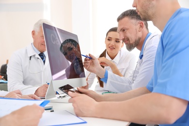 Photo of Group of doctors attending meeting in clinic. Cardiology conference