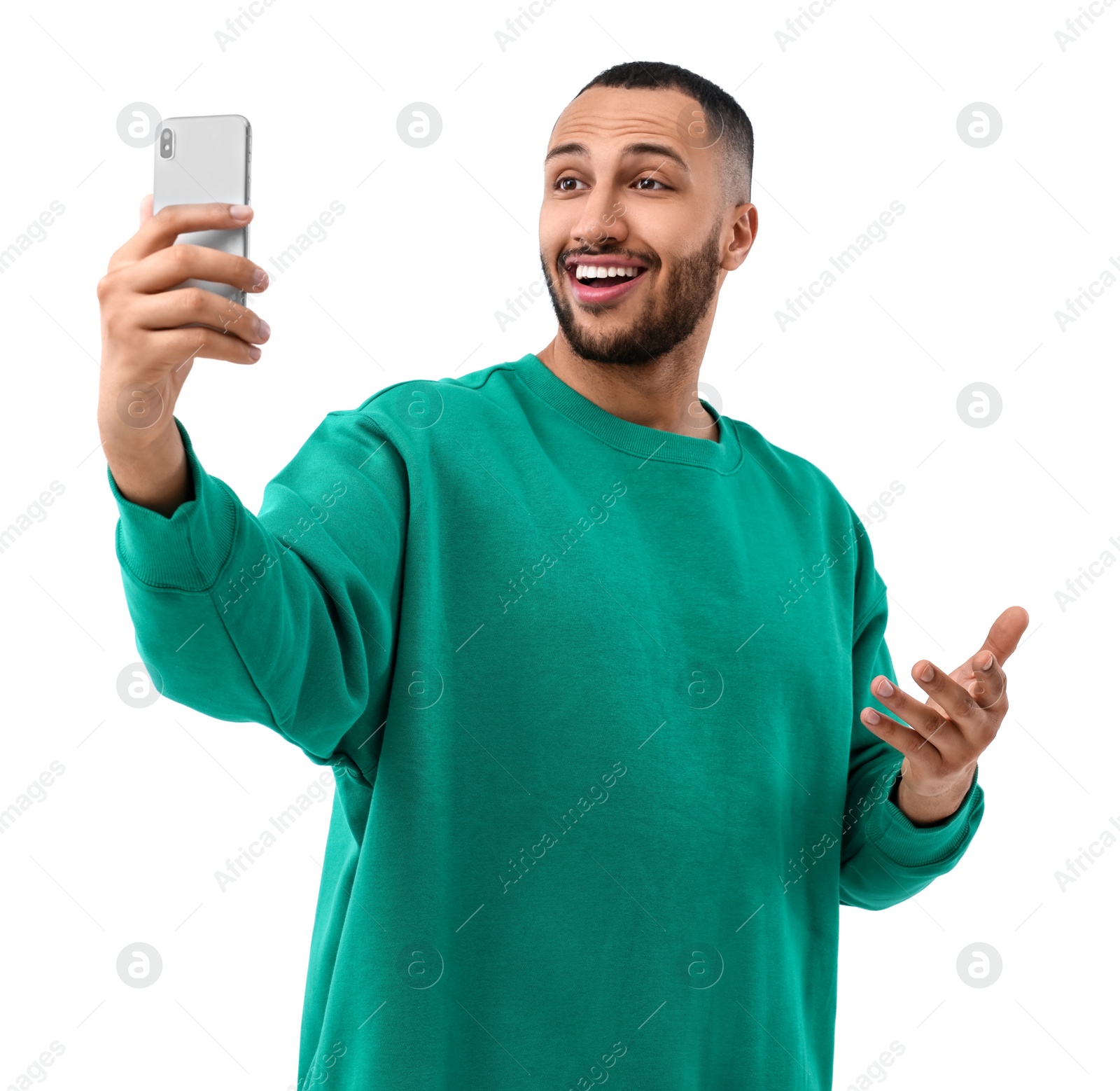 Photo of Smiling young man taking selfie with smartphone on white background