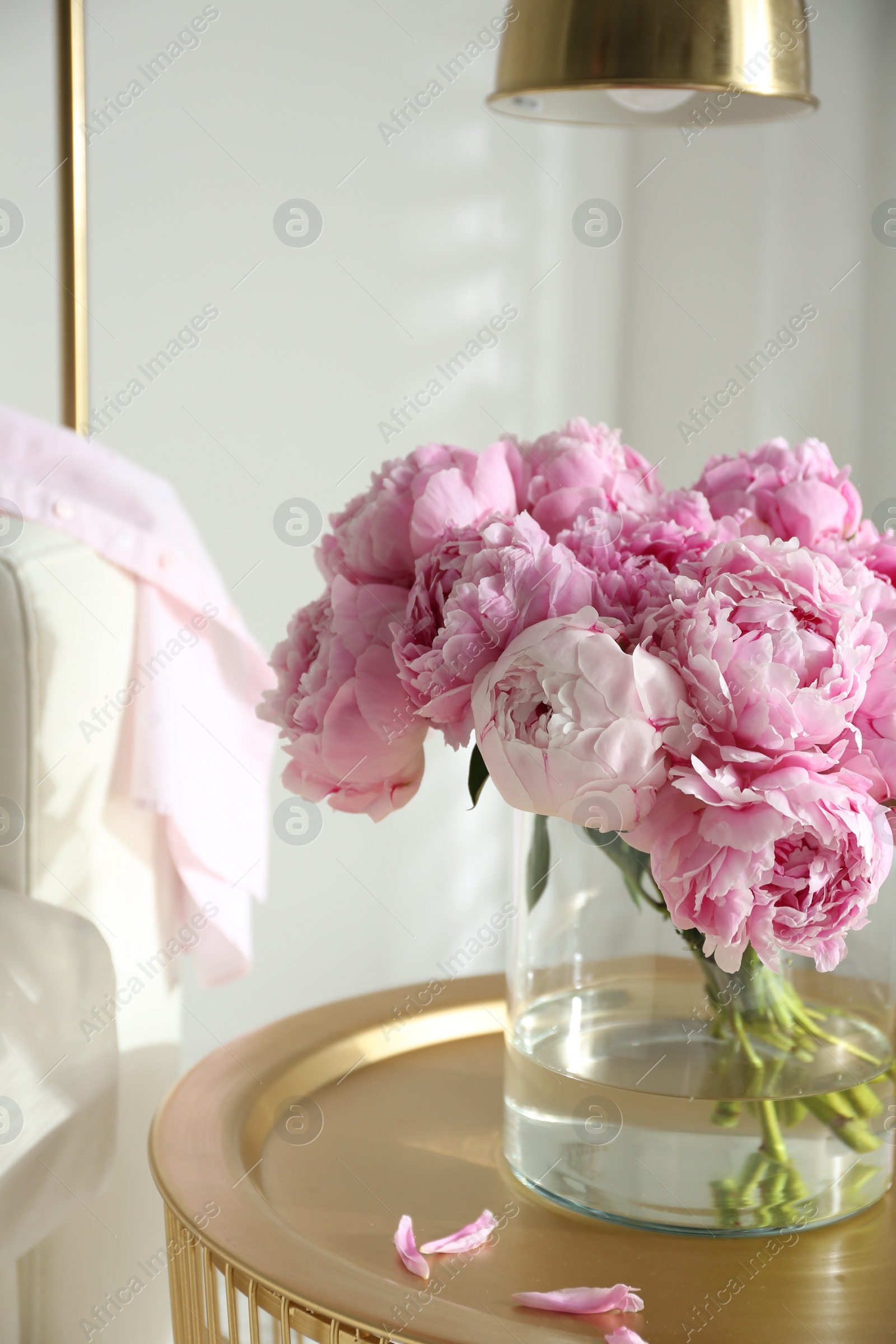 Photo of Bouquet of beautiful peonies on table indoors