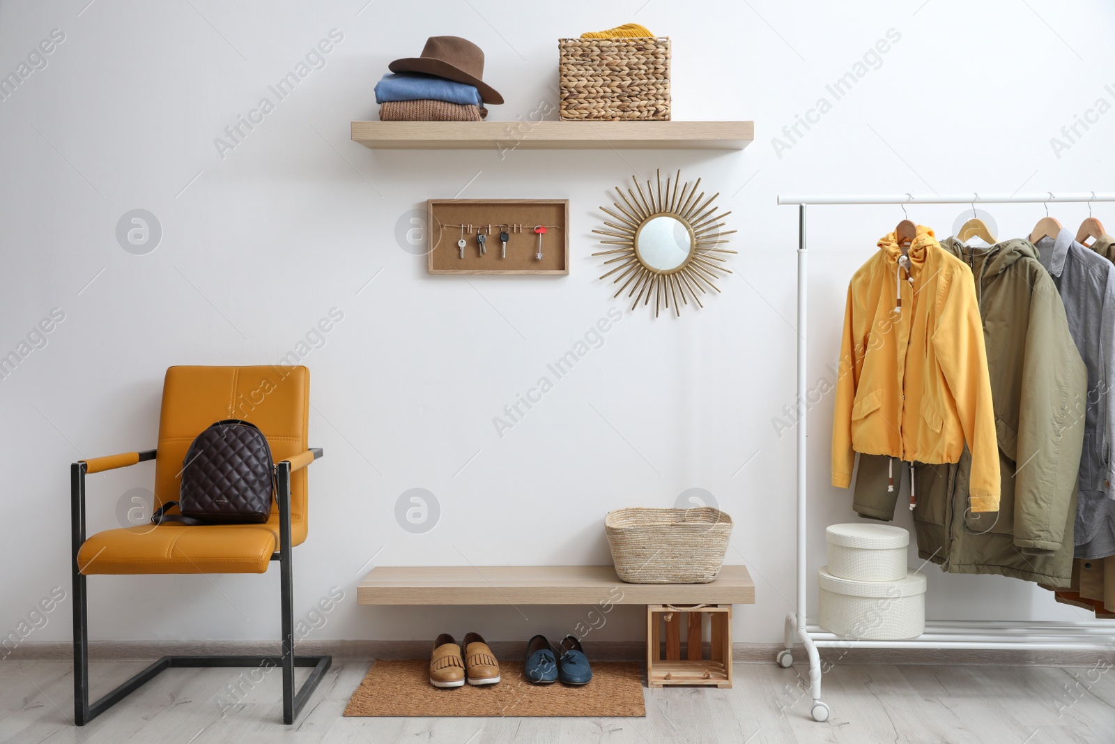 Photo of Hallway interior with stylish furniture, clothes and accessories
