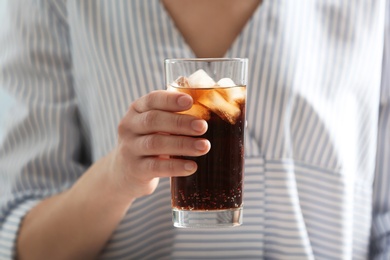 Photo of Woman with glass of cold cola, closeup