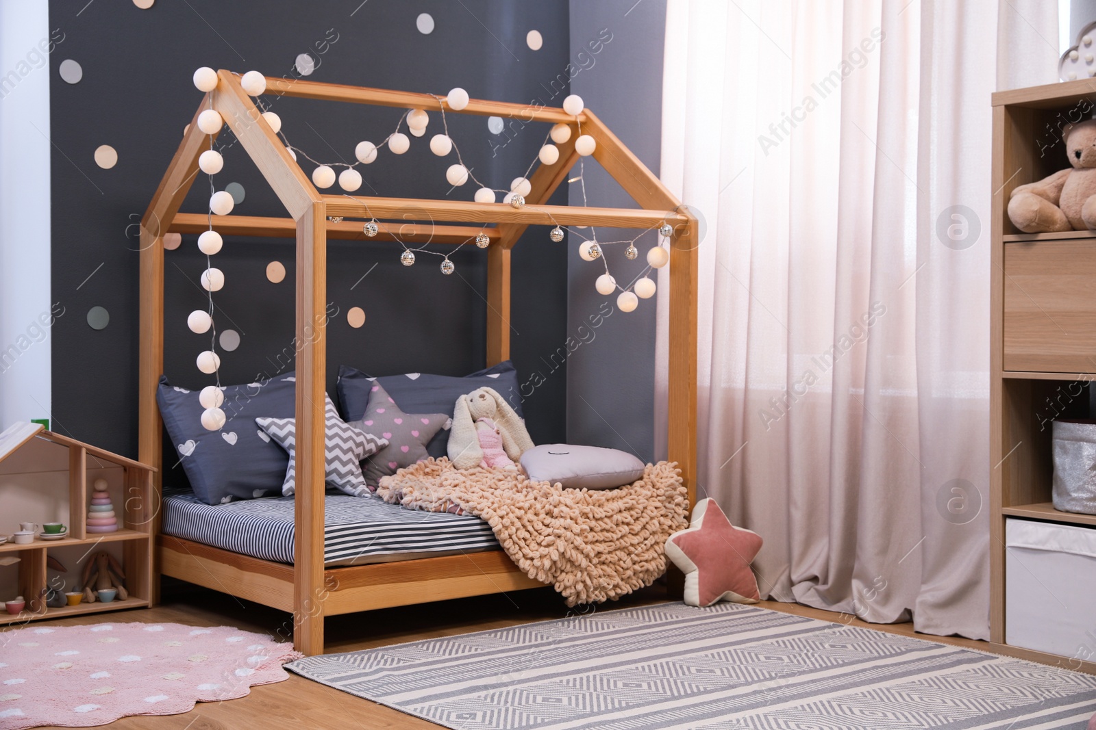 Photo of Stylish child room interior with comfortable bed