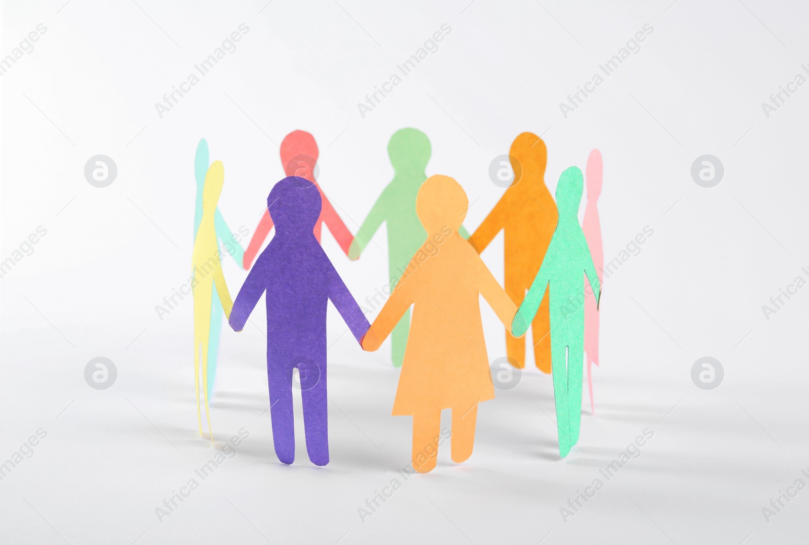 Photo of Paper human figures making circle on white background. Diversity and Inclusion concept