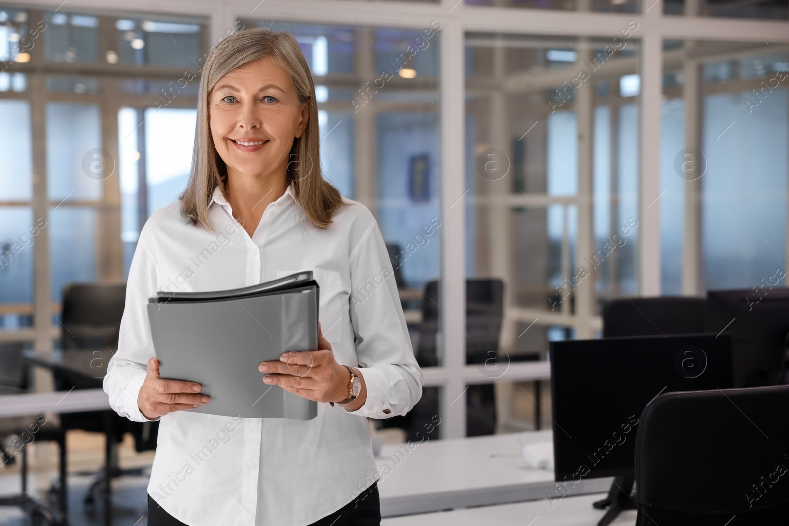 Photo of Smiling woman with folders in office, space for text. Lawyer, businesswoman, accountant or manager