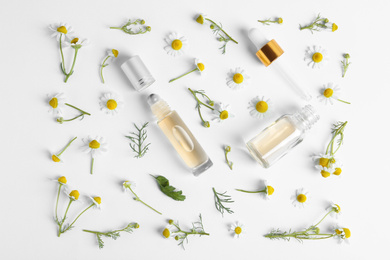 Flat lay composition with chamomile essential oil on white background