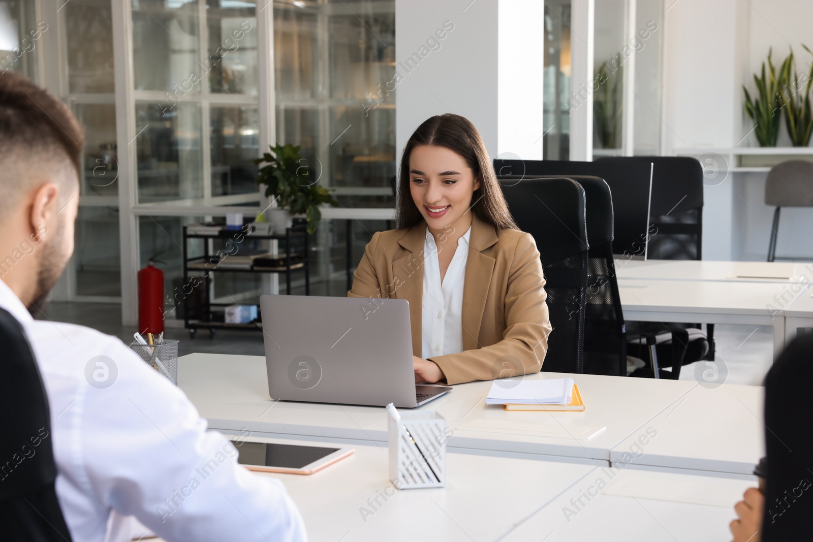 Photo of Colleagues working together in open plan office