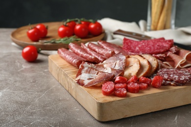 Cutting board with different sliced meat products served on table