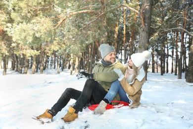 Photo of Happy couple sleighing outdoors on winter day