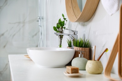 Photo of Modern bathroom interior with vessel sink and decor elements