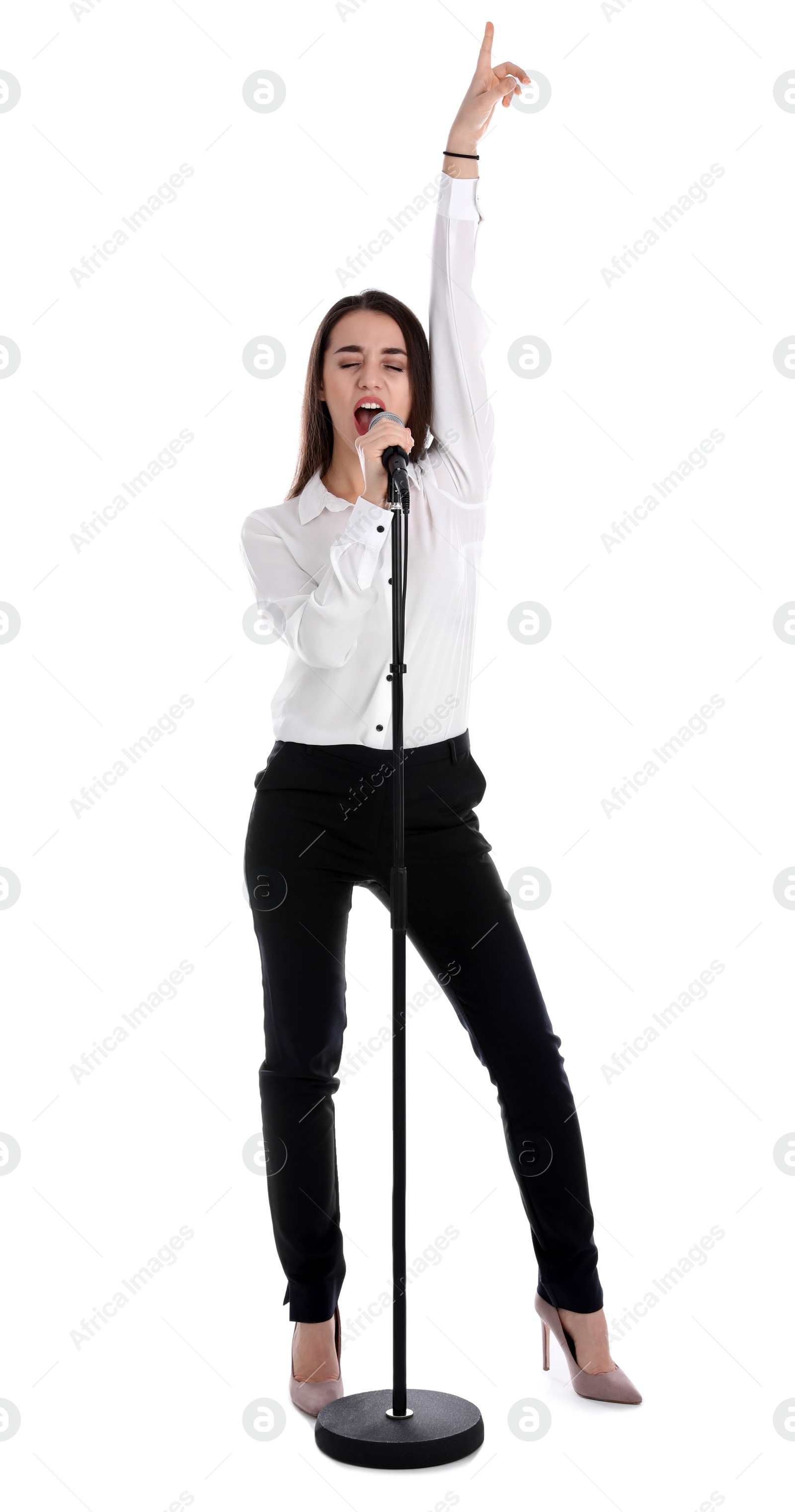 Photo of Young stylish woman singing in microphone on white background