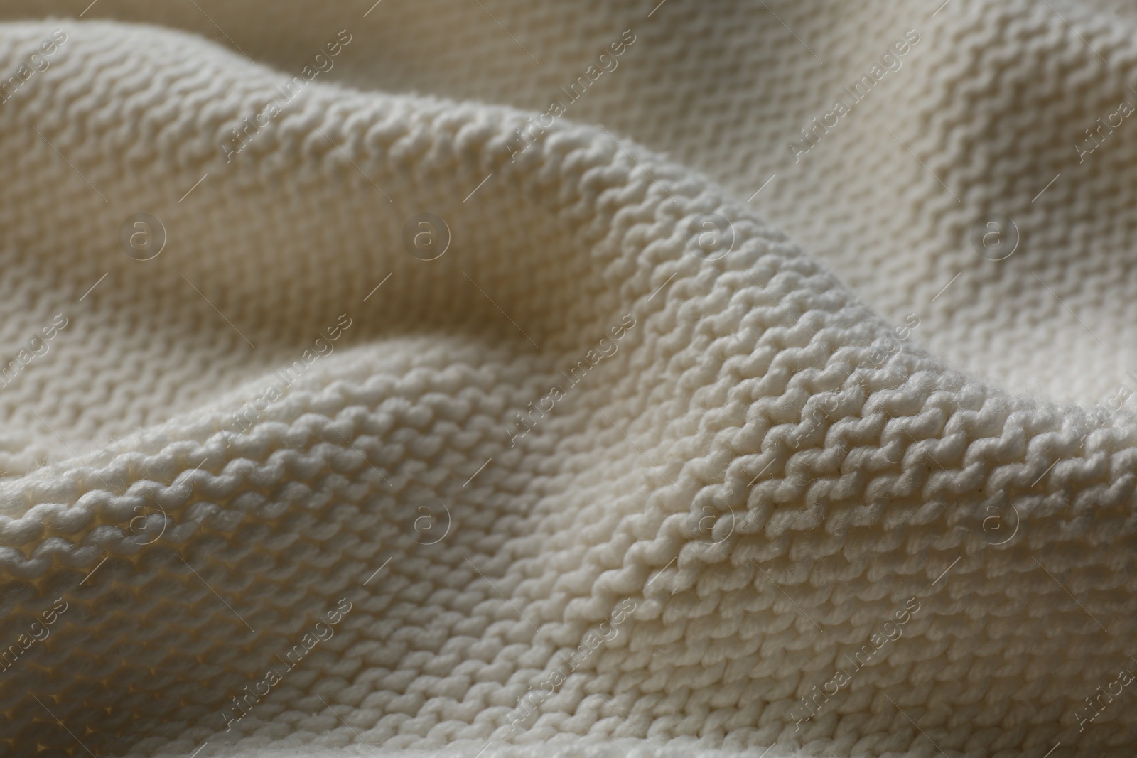 Photo of Beautiful white knitted fabric as background, closeup