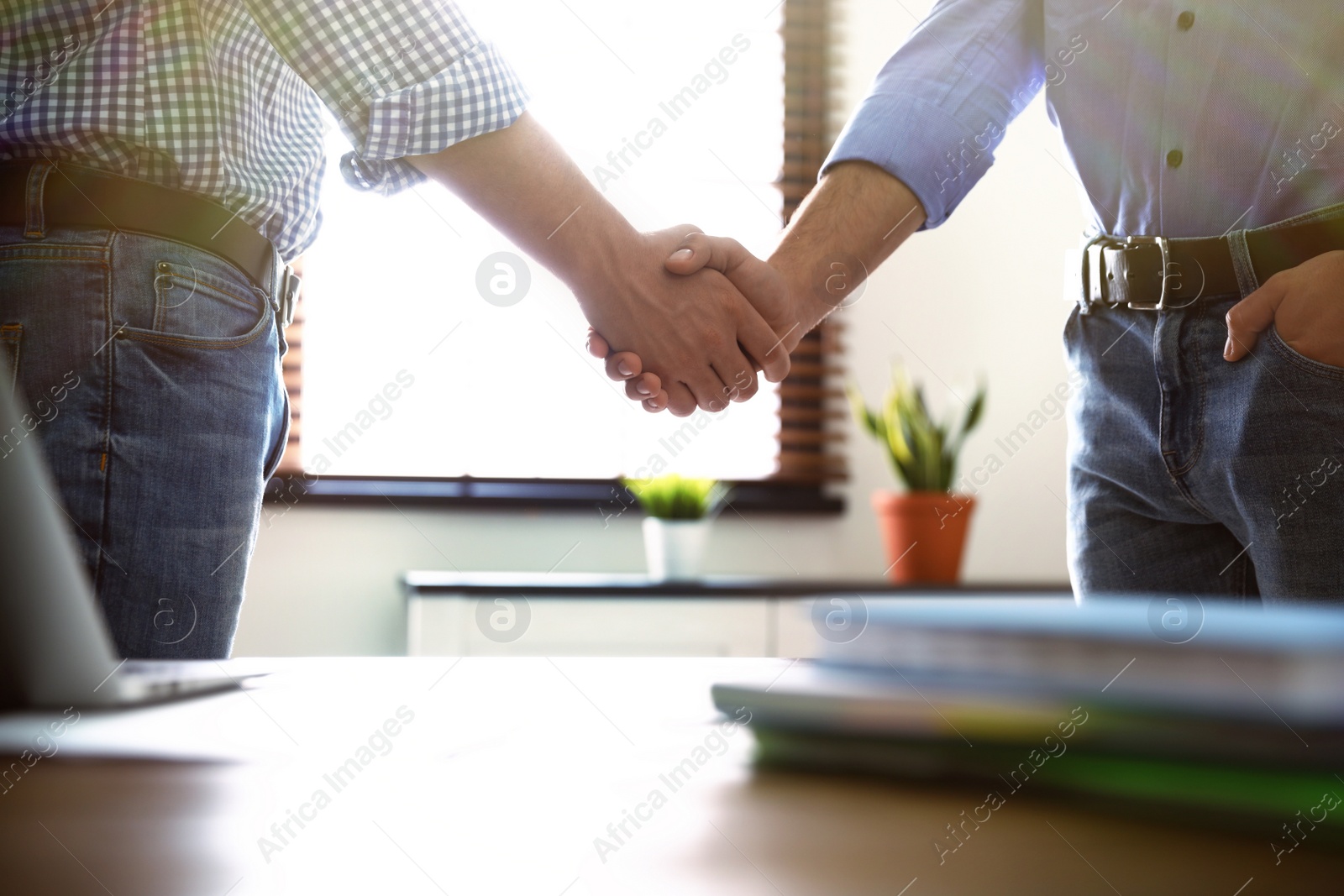 Photo of Business partners shaking hands after meeting, closeup