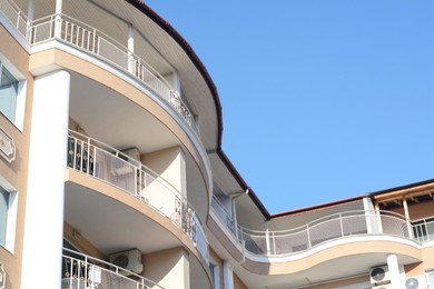 Photo of Exterior of beautiful residential building with balconies, low angle view