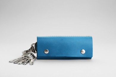 Photo of Leather case with keys on light grey background