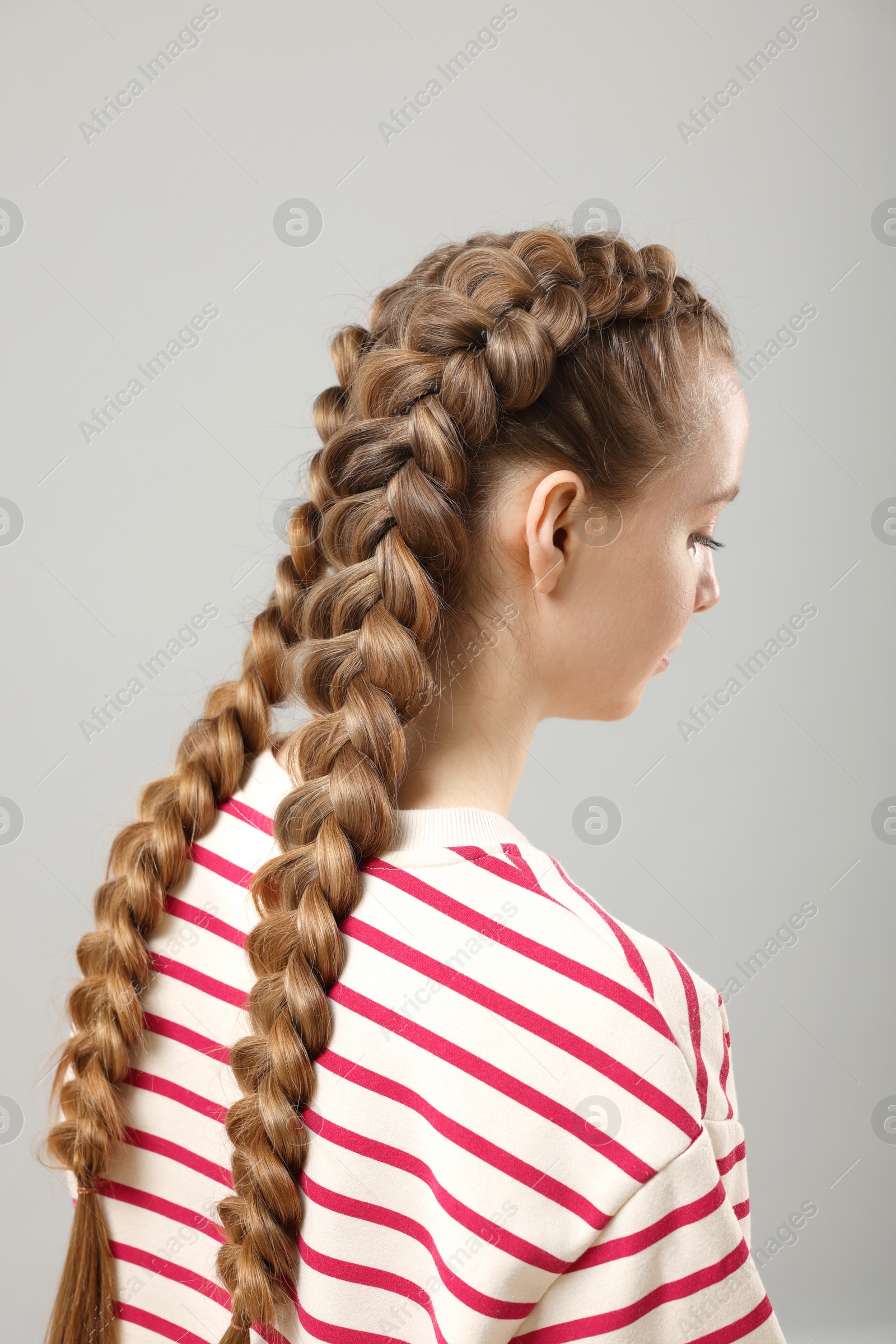 Photo of Woman with braided hair on grey background