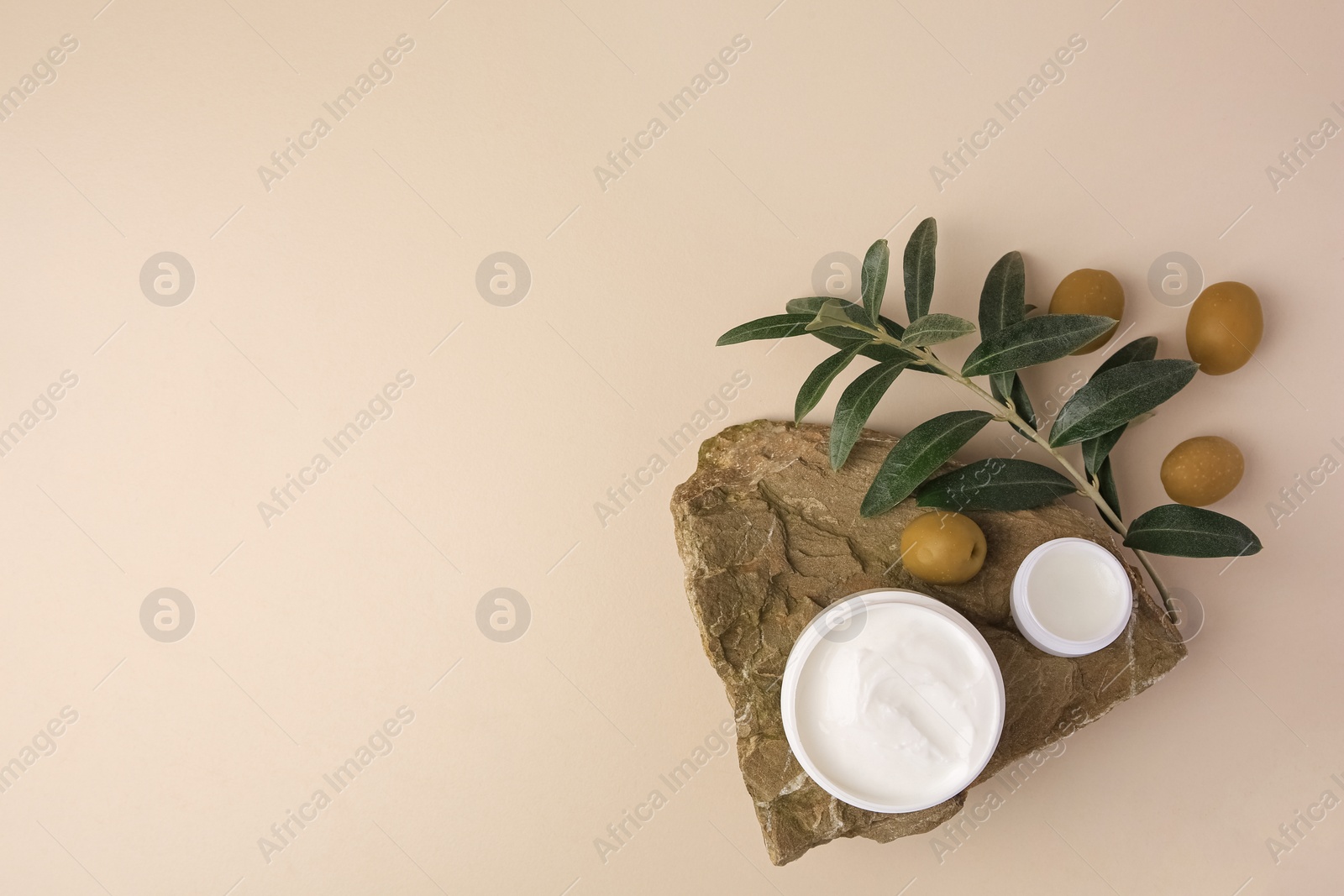 Photo of Flat lay composition with different natural cosmetic products on beige background. Space for text