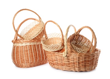 Photo of Many decorative wicker baskets on white background