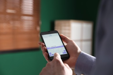 Photo of Man sending message with text I Love You indoors, closeup