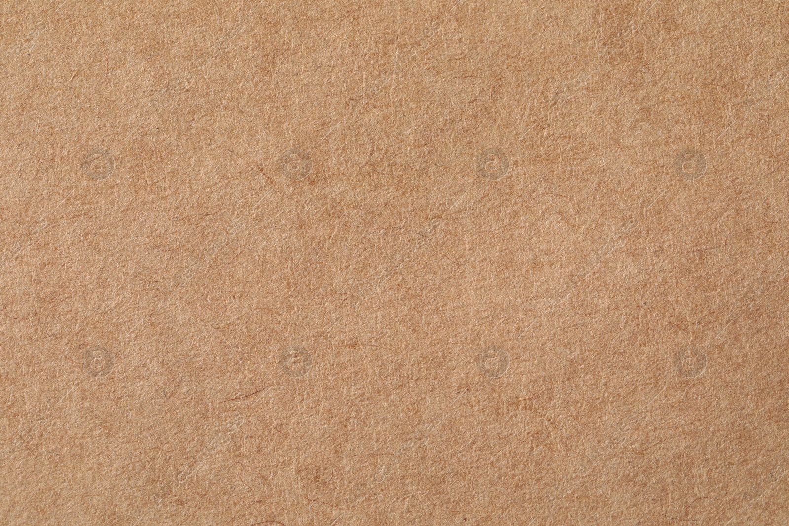 Photo of Texture of kraft paper sheet as background, closeup