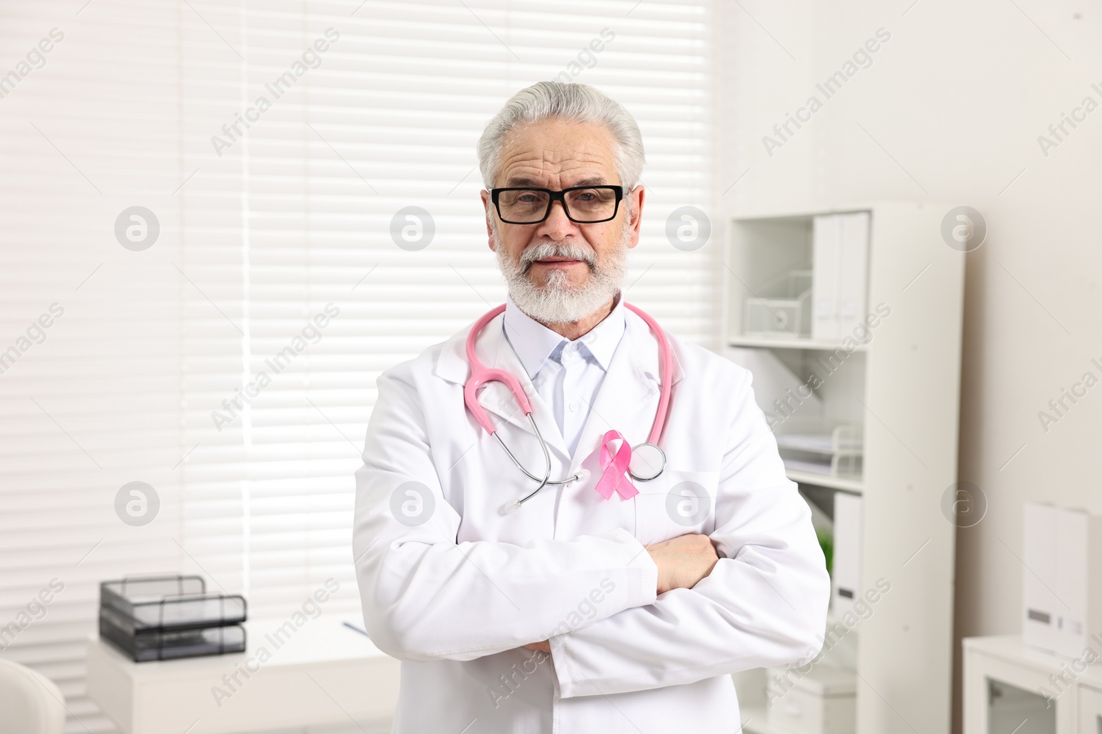 Photo of Mammologist with pink ribbon in hospital. Breast cancer awareness