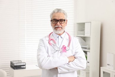 Mammologist with pink ribbon in hospital. Breast cancer awareness