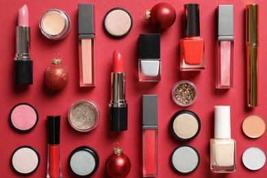 Photo of Flat lay composition with makeup products and Christmas decor on color background