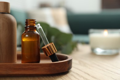 Photo of Aromatherapy. Bottles of essential oil on wooden table, space for text