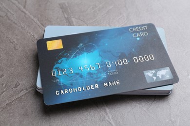 Photo of Credit cards on grey textured table, closeup