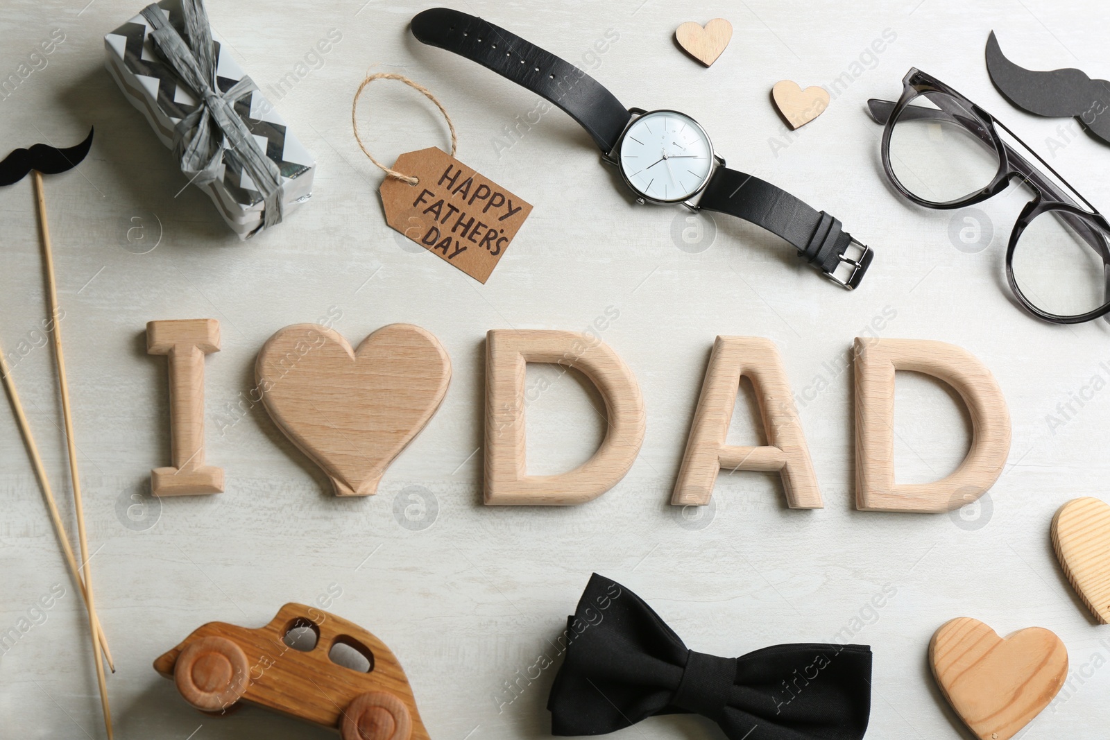 Photo of Flat lay composition with phrase I LOVE DAD on white background. Happy Father's day