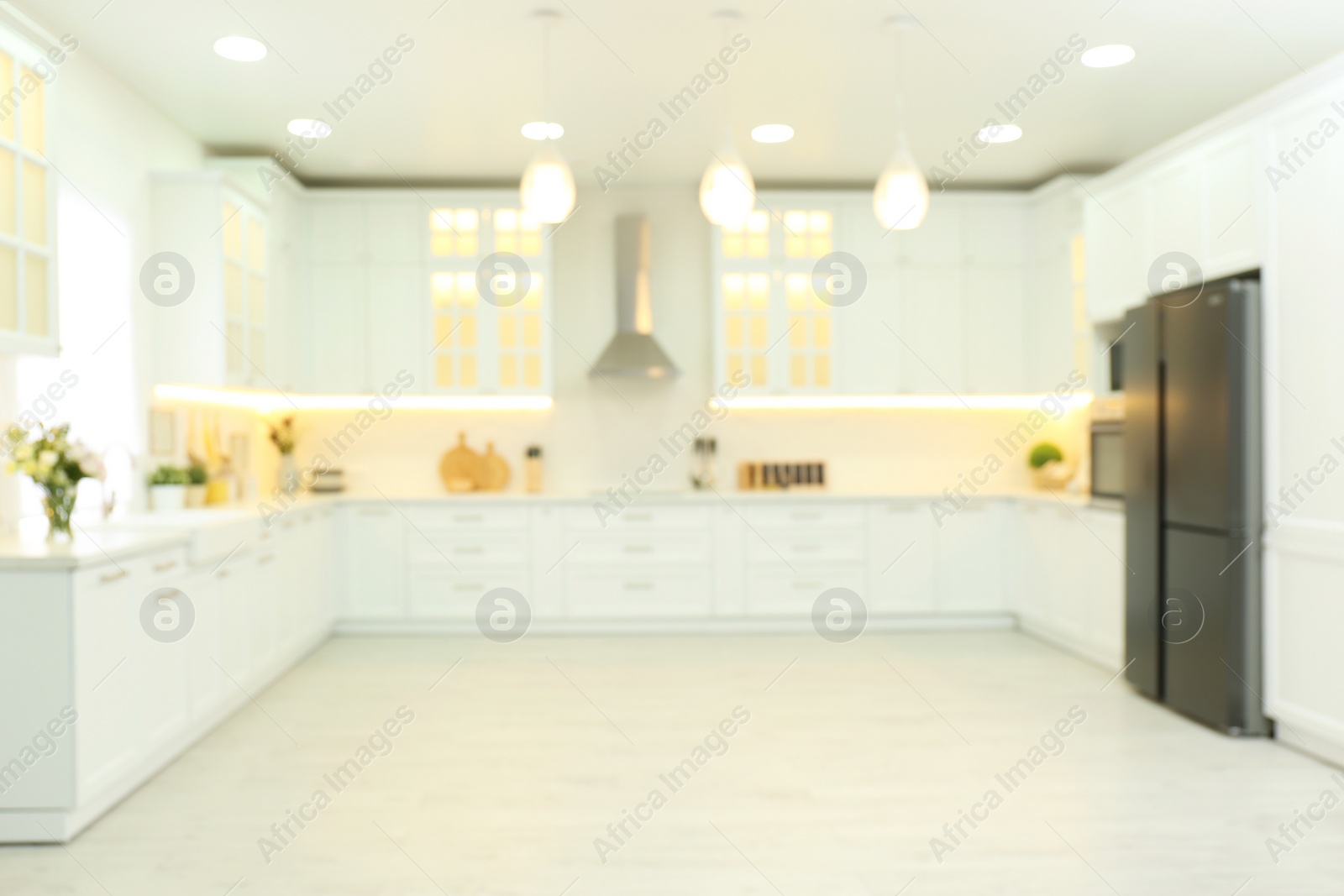 Photo of Blurred view of modern kitchen interior with stylish furniture