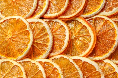 Heap of dry orange slices as background, top view