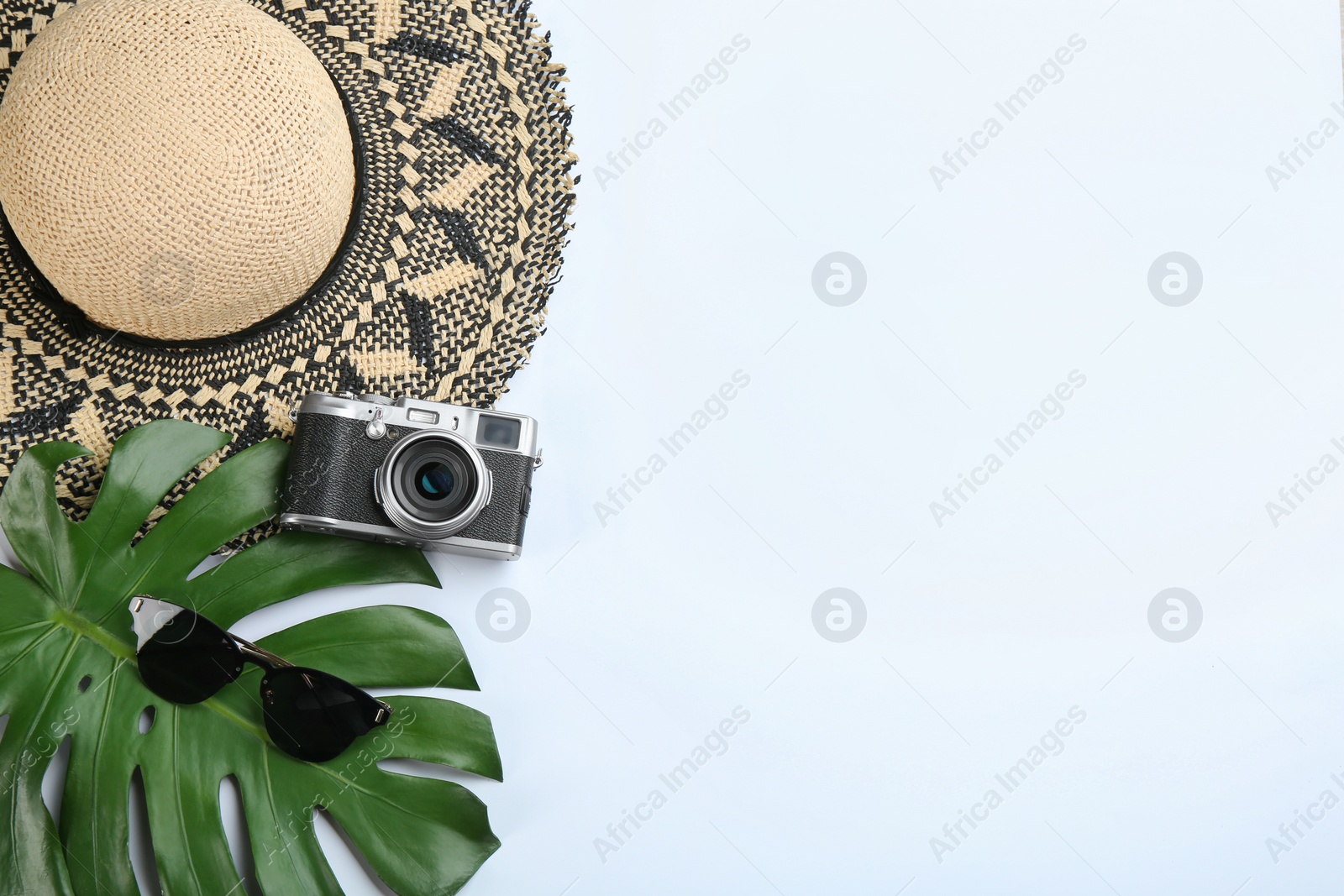 Photo of Camera for professional photographer and beach accessories on white background, top view