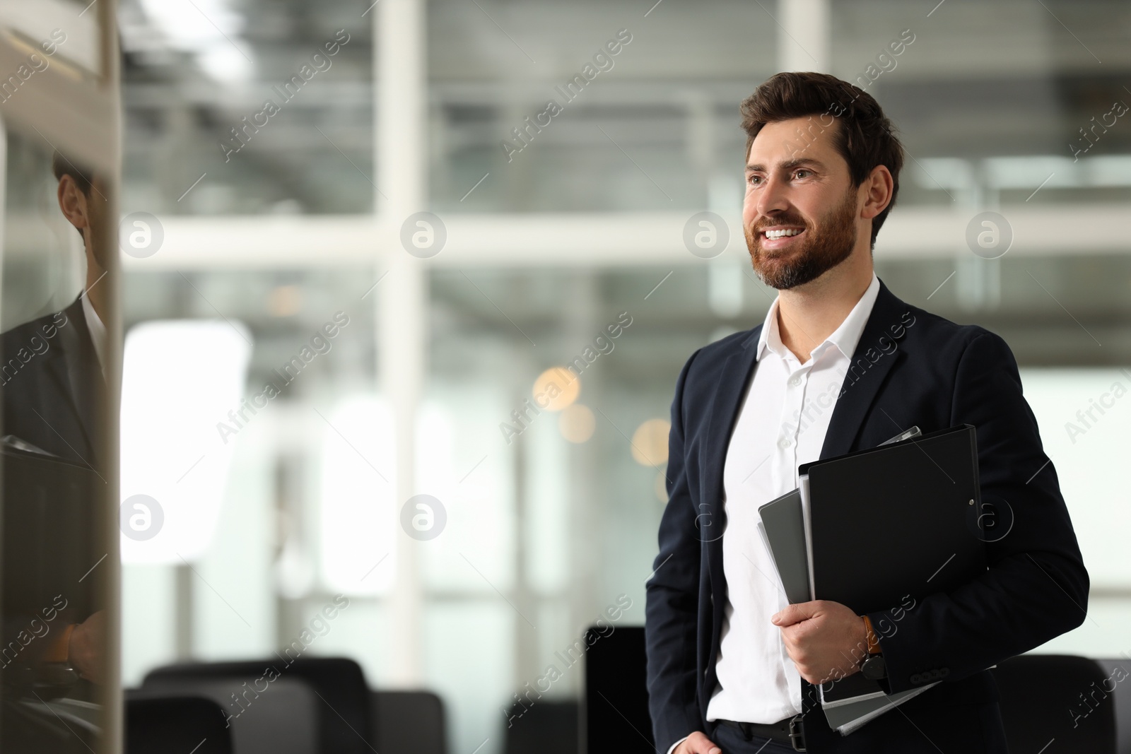 Photo of Smiling man with folders in office, space for text. Lawyer, businessman, accountant or manager