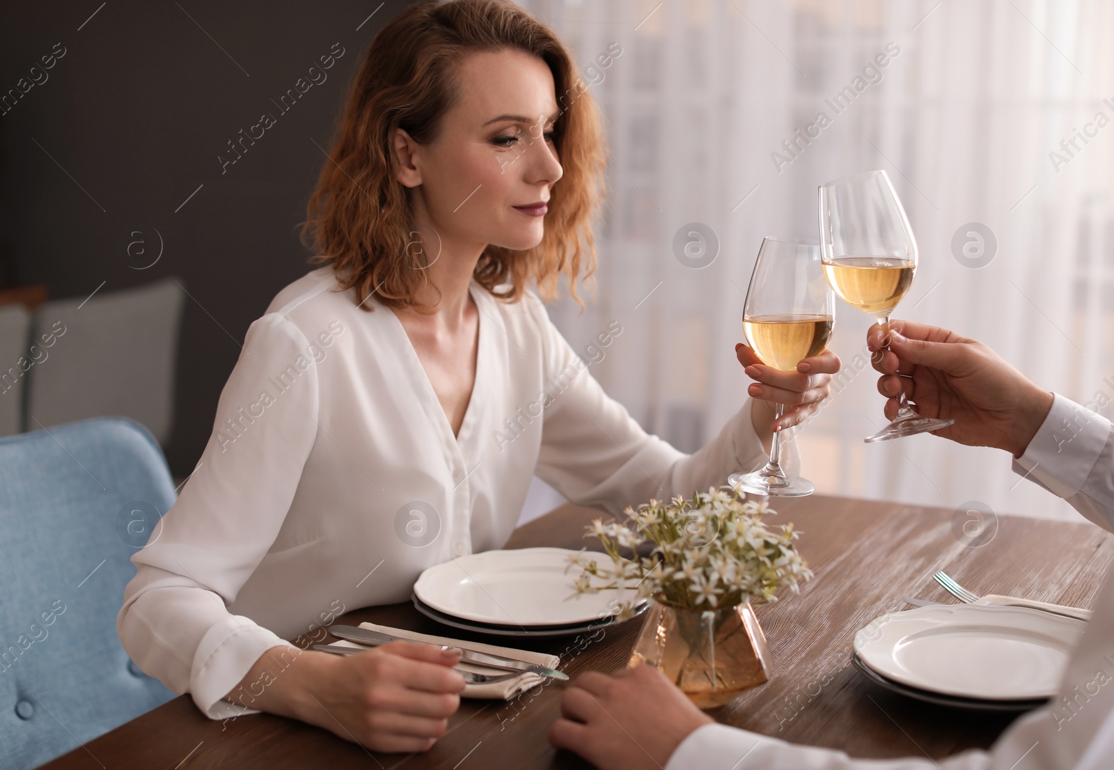 Photo of Young couple with glasses of delicious wine in restaurant