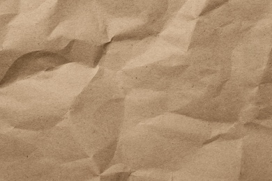 Brown crumpled paper texture as background, top view