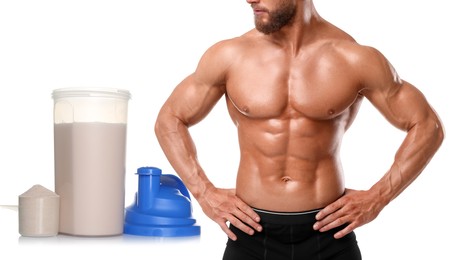 Bodybuilding. Man with muscular torso, protein powder and shaker isolated on white