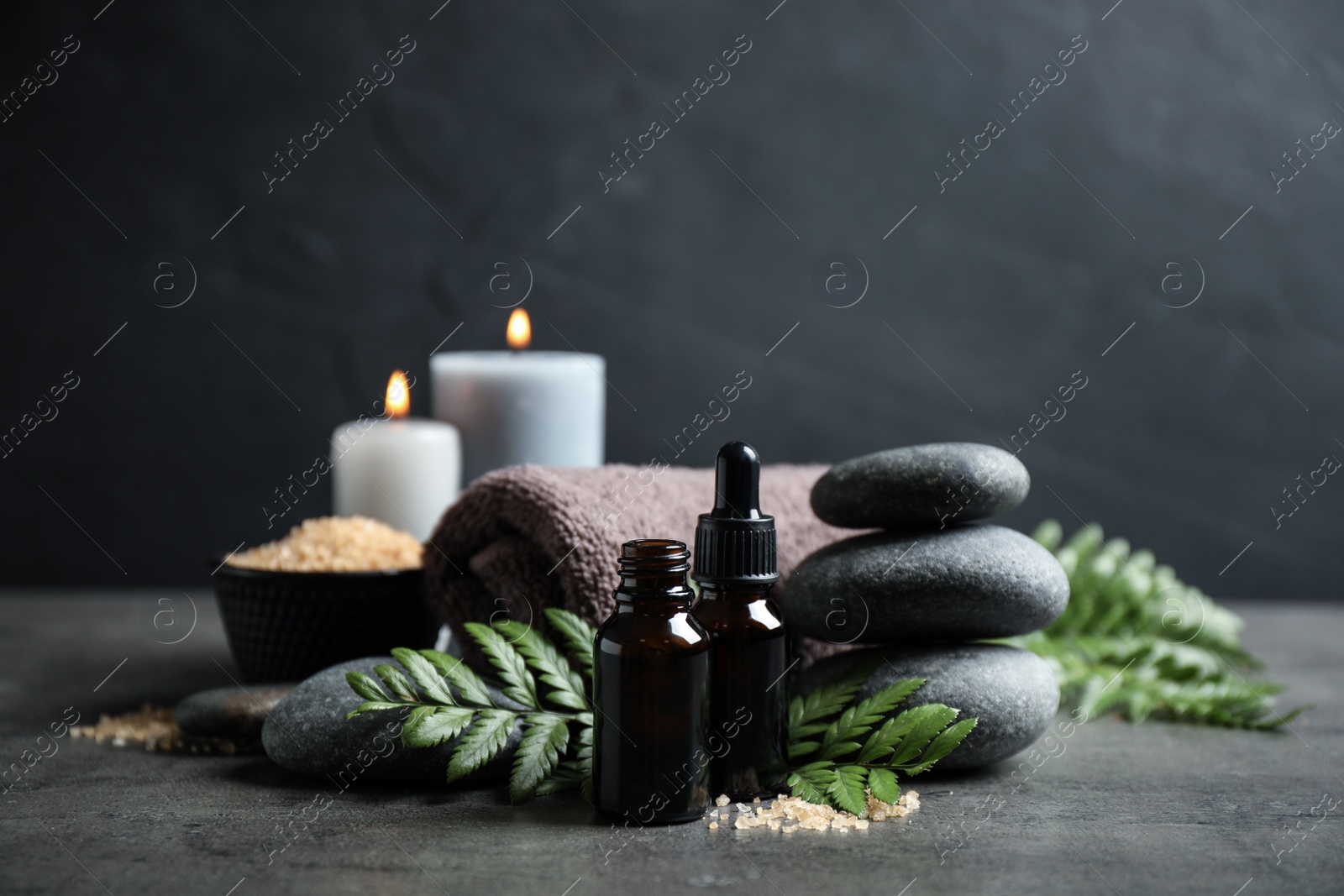 Photo of Spa composition with aroma oil on grey table